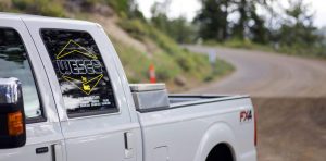 wesco decal on a pickup truck on a winding road